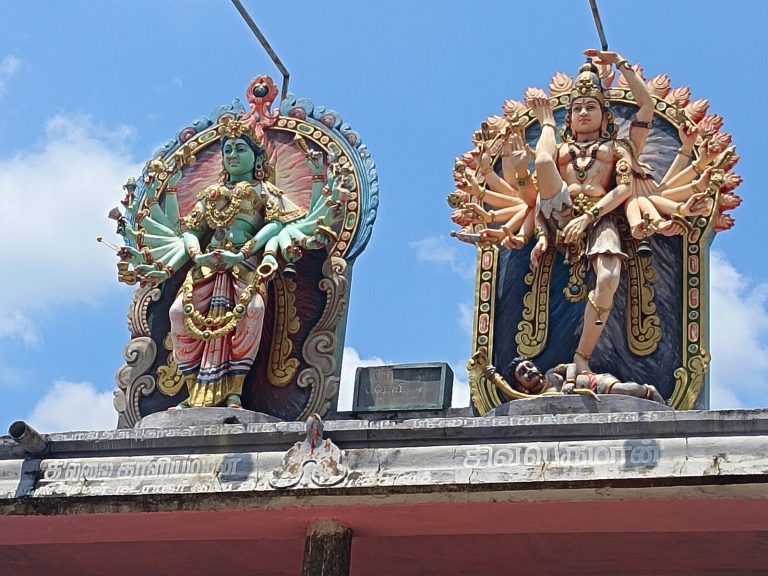 Granite gopuram and golden roof of Thillai Nataraja Temple reflected in Sivaganga tank