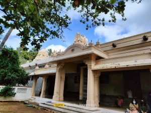 Shaded courtyard and stone buildings at Sri Ramanasramam at the foot of Arunachala hill