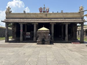 Granite gopuram tower and ancient stone pillars at Nithya Kalyana Perumal Temple in Thiruvidandhai